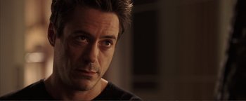 Movie still from “Kiss Kiss Bang Bang” (2005), directed by Shane Black – A man's face in a dark room; Close Up shot, Over the shoulder angle