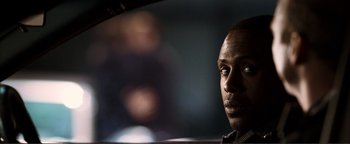 Movie still from “Kiss Kiss Bang Bang” (2005), directed by Shane Black – A person in a car looking at the camera; Close Up shot, Over the shoulder angle