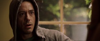 Movie still from “Kiss Kiss Bang Bang” (2005), directed by Shane Black – A person wearing a hooded sweatshirt; Close Up shot, Over the shoulder angle