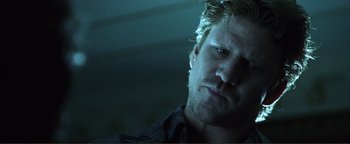 Movie still from “Kiss Kiss Bang Bang” (2005), directed by Shane Black – A person wearing a black shirt; Close Up shot, Low angle