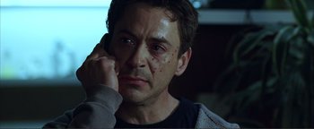 Movie still from “Kiss Kiss Bang Bang” (2005), directed by Shane Black – A person holding a cell phone to his ear; Close Up shot, Over the shoulder angle