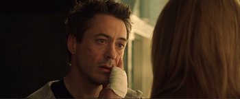 Movie still from “Kiss Kiss Bang Bang” (2005), directed by Shane Black – A person with a bandage on his face; Close Up shot, Over the shoulder angle