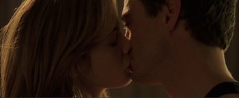 Movie still from “Kiss Kiss Bang Bang” (2005), directed by Shane Black – A man and a woman kissing each other; Extreme Close Up shot, Low angle