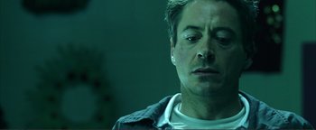 Movie still from “Kiss Kiss Bang Bang” (2005), directed by Shane Black – A person wearing a white shirt; Close Up shot, Low angle
