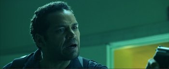 Movie still from “Kiss Kiss Bang Bang” (2005), directed by Shane Black – A person in a room near a wall; Close Up shot, Low angle