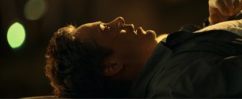 Movie still from “Kiss Kiss Bang Bang” (2005), directed by Shane Black – A man laying down with his eyes closed; Close Up shot, Overhead angle