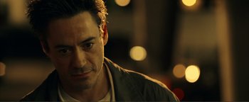 Movie still from “Kiss Kiss Bang Bang” (2005), directed by Shane Black – A man's face in the dark; Close Up shot, Over the shoulder angle