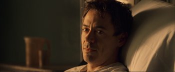 Movie still from “Kiss Kiss Bang Bang” (2005), directed by Shane Black – A person sitting in a chair; Close Up shot, High angle
