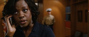 Movie still from “Knight and Day” (2010), directed by James Mangold – A woman wearing a uniform standing in front of a man in a uniform; Close Up shot, Over the shoulder angle