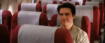 Movie still from “Knight and Day” (2010), directed by James Mangold – A person sitting on a seat on an airplane; Close Up shot, Over the shoulder angle