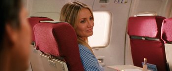 Movie still from “Knight and Day” (2010), directed by James Mangold – A woman sitting on a seat on an airplane; Close Up shot, Over the shoulder angle