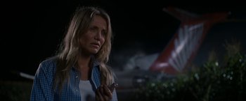 Movie still from “Knight and Day” (2010), directed by James Mangold – A woman holding a cigarette in her hand; Close Up shot, Over the shoulder angle