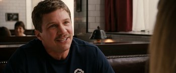 Movie still from “Knight and Day” (2010), directed by James Mangold – A person sitting in a room; Close Up shot, Over the shoulder angle