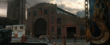 Movie still from “Knight and Day” (2010), directed by James Mangold – Two people walking in front of an old warehouse; Extreme Wide shot, Low angle