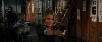 Movie still from “Knight and Day” (2010), directed by James Mangold – A woman is holding a gun in her hand; Medium shot, Over the shoulder angle