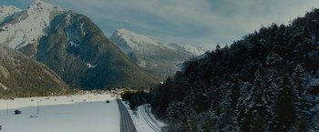 Movie still from “Knight and Day” (2010), directed by James Mangold – A snowy mountain with a road going through it; Extreme Wide shot, High angle