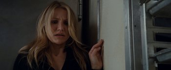 Movie still from “Knight and Day” (2010), directed by James Mangold – A woman leaning against a wall with her hand on her face; Close Up shot, High angle