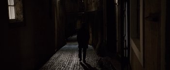 Movie still from “Knight and Day” (2010), directed by James Mangold – Two people walking down a dark alley at night; Wide shot, High angle