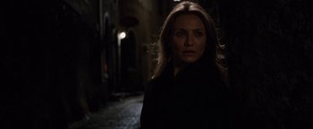 Movie still from “Knight and Day” (2010), directed by James Mangold – A woman standing in the dark in a dark alley; Close Up shot, Over the shoulder angle