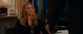 Movie still from “Knight and Day” (2010), directed by James Mangold – A woman sitting at a table with a glass of wine; Close Up shot, Over the shoulder angle