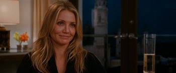 Movie still from “Knight and Day” (2010), directed by James Mangold – Cameron diaz is smiling for the camera in front of a window; Close Up shot, Over the shoulder angle