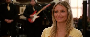Movie still from “Knight and Day” (2010), directed by James Mangold – A woman standing in front of a man playing a guitar; Close Up shot, Over the shoulder angle