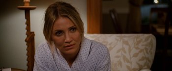 Movie still from “Knight and Day” (2010), directed by James Mangold – A person sitting on a couch wearing a robe; Close Up shot, Over the shoulder angle
