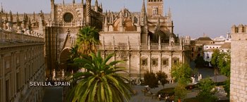 Movie still from “Knight and Day” (2010), directed by James Mangold – An old building with a very tall tower and a very large cathedral; Extreme Wide shot, High angle
