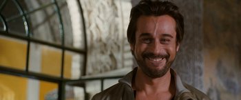 Movie still from “Knight and Day” (2010), directed by James Mangold – A person with a beard smiling; Close Up shot, Over the shoulder angle
