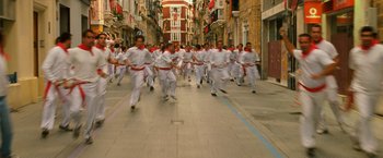 Movie still from “Knight and Day” (2010), directed by James Mangold – A group of people running down a street; Extreme Wide shot, High angle