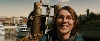 Movie still from “Knight and Day” (2010), directed by James Mangold – A man with a beard wearing glasses and smiling; Close Up shot, Low angle