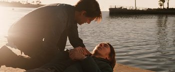 Movie still from “Knight and Day” (2010), directed by James Mangold – Two people on the beach one of them is holding a knife; Medium shot, Over the shoulder angle