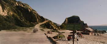 Movie still from “Knight and Day” (2010), directed by James Mangold – Two motorcycles are parked on the side of the road; Extreme Wide shot, High angle