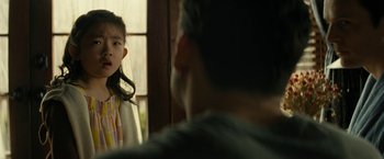 Movie still from “Knock at the Cabin” (2023), directed by M. Night Shyamalan – A young girl standing in front of a man in front of a window; Close Up shot, Over the shoulder angle