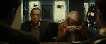 Movie still from “Knock at the Cabin” (2023), directed by M. Night Shyamalan – A man and a woman sitting at a dinner table; Medium shot, Over the shoulder angle