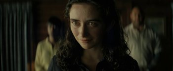 Movie still from “Knock at the Cabin” (2023), directed by M. Night Shyamalan – A person with long curly hair; Close Up shot, Over the shoulder angle