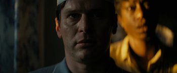 Movie still from “Knock at the Cabin” (2023), directed by M. Night Shyamalan – A man's face in the dark; Close Up shot, Low angle