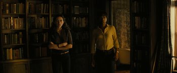 Movie still from “Knock at the Cabin” (2023), directed by M. Night Shyamalan – Two people standing in a room next to each other; Medium shot, Low angle