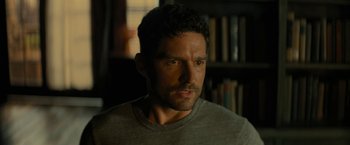 Movie still from “Knock at the Cabin” (2023), directed by M. Night Shyamalan – A person wearing a gray shirt; Close Up shot, Over the shoulder angle
