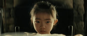 Movie still from “Knock at the Cabin” (2023), directed by M. Night Shyamalan – A little girl is looking into the camera; Close Up shot, High angle