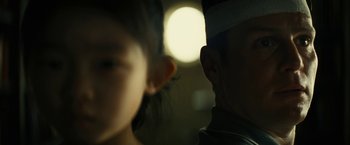 Movie still from “Knock at the Cabin” (2023), directed by M. Night Shyamalan – A person's face and a person's head; Close Up shot, Low angle