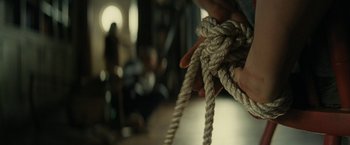 Movie still from “Knock at the Cabin” (2023), directed by M. Night Shyamalan – A person holding a rope in their hands; Extreme Close Up shot, High angle