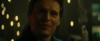 Movie still from “Knock at the Cabin” (2023), directed by M. Night Shyamalan – A man's face in the dark; Close Up shot, Over the shoulder angle