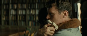 Movie still from “Knock at the Cabin” (2023), directed by M. Night Shyamalan – A man and a woman kissing in front of a book shelf; Close Up shot, Over the shoulder angle