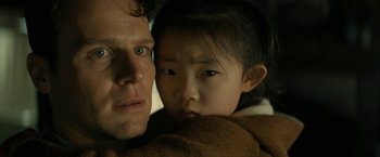 Movie still from “Knock at the Cabin” (2023), directed by M. Night Shyamalan – A man and a little girl are snuggled together; Close Up shot, Over the shoulder angle