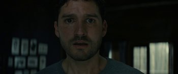 Movie still from “Knock at the Cabin” (2023), directed by M. Night Shyamalan – A person looking at the camera; Close Up shot, Low angle