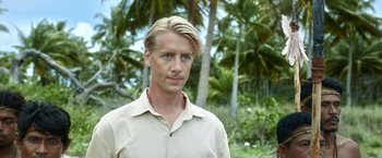 Movie still from “Kon-Tiki” (2012), directed by Espen Sandberg – A person wearing a shirt near some trees; Close Up shot, Low angle