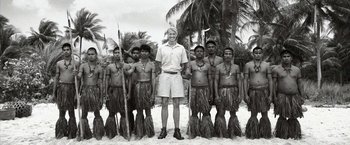 Movie still from “Kon-Tiki” (2012), directed by Espen Sandberg – Black and white photograph of a group of men in grass skirts; Wide shot, High angle