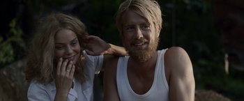 Movie still from “Kon-Tiki” (2012), directed by Espen Sandberg – A man and a woman smiling for the camera; Close Up shot, Over the shoulder angle