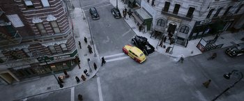 Movie still from “Kon-Tiki” (2012), directed by Espen Sandberg – An aerial view of an intersection with a yellow car and an old car; Extreme Wide shot, High angle